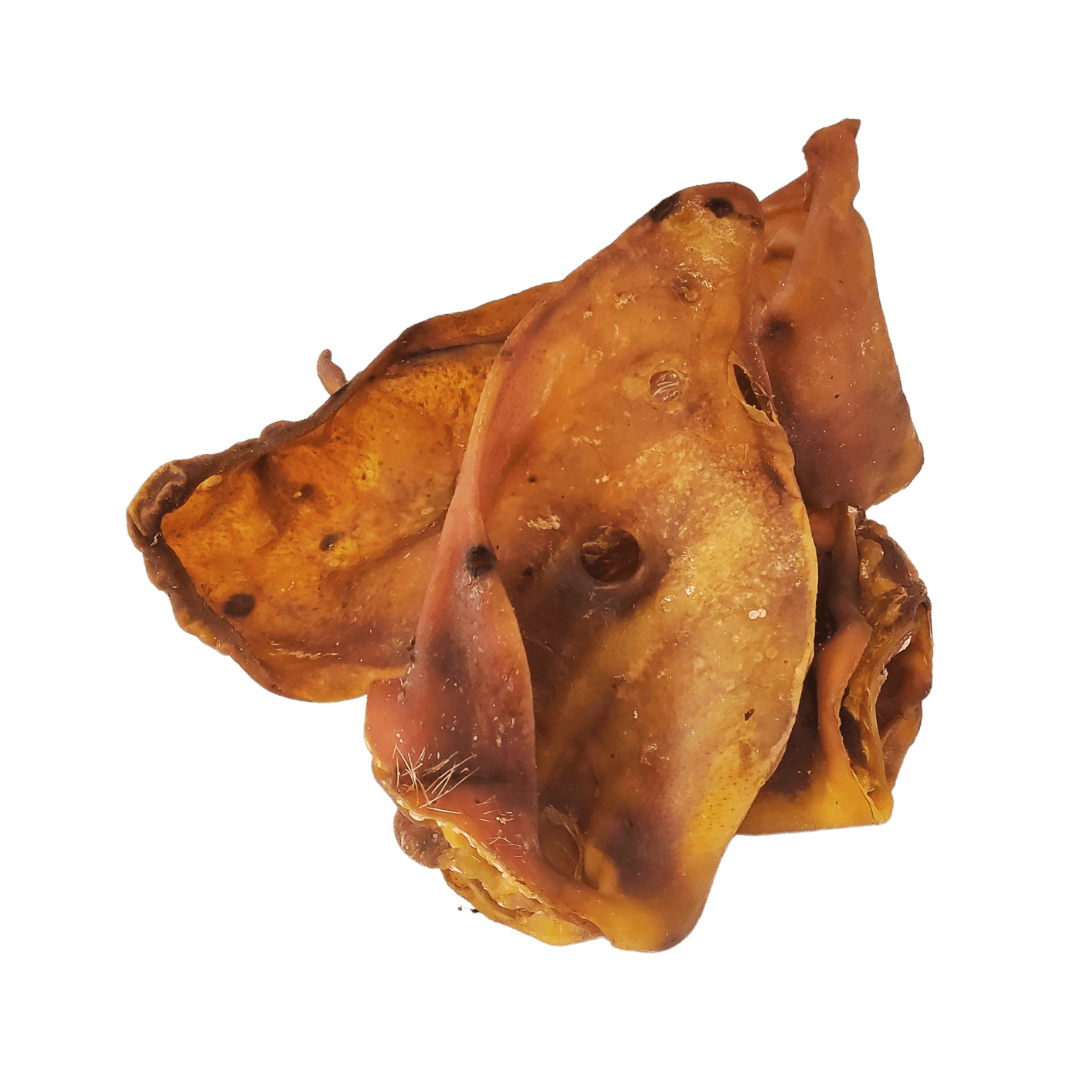 Three pigs ears natural dog treats stacked on top of each other on an all white background.