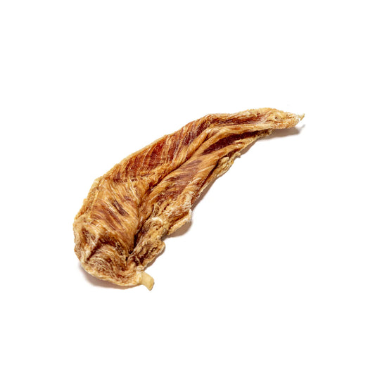 Chicken jerky natural dog treats on an all white background.