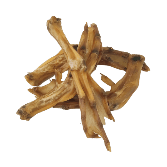 Four air-dried duck feet natural dog treats interlocked together on a white background.