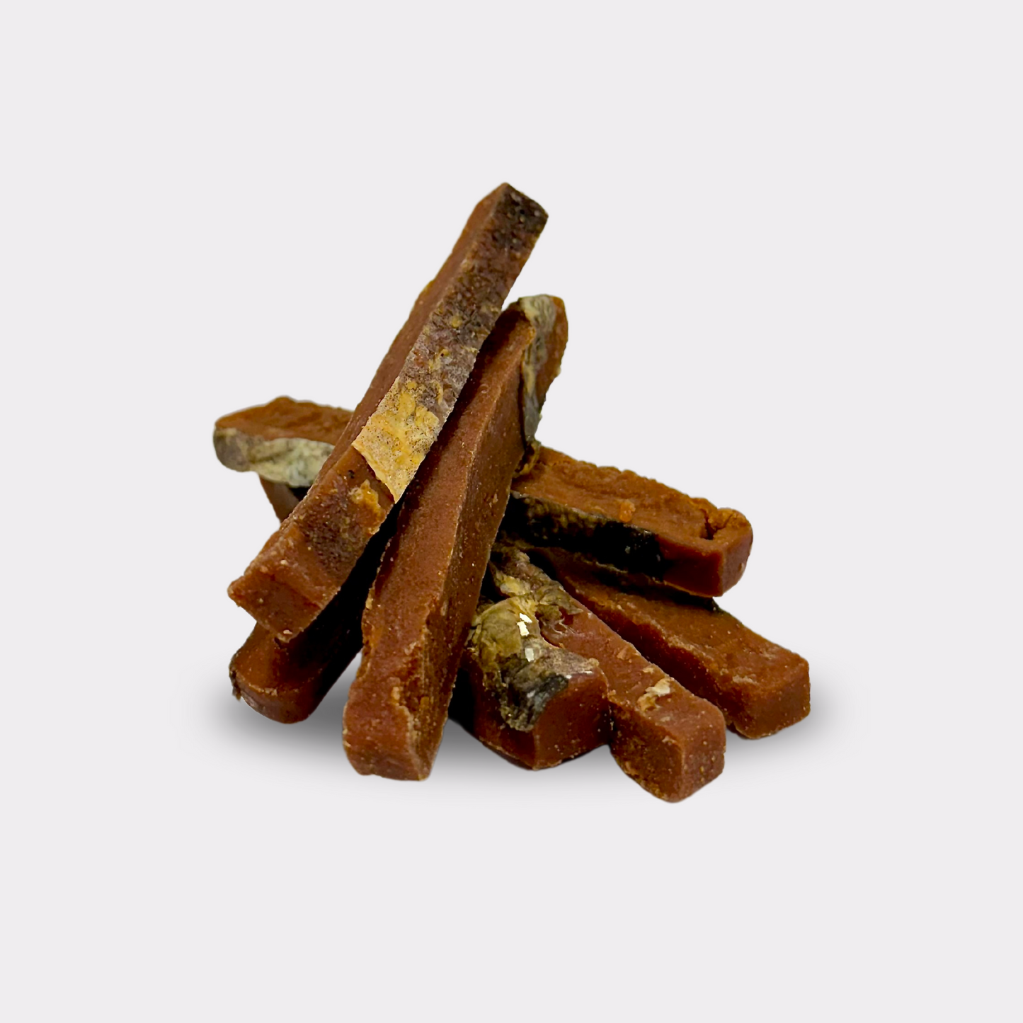 7 salmon skin strips natural dog treats stacked on top of each other on an all white background.