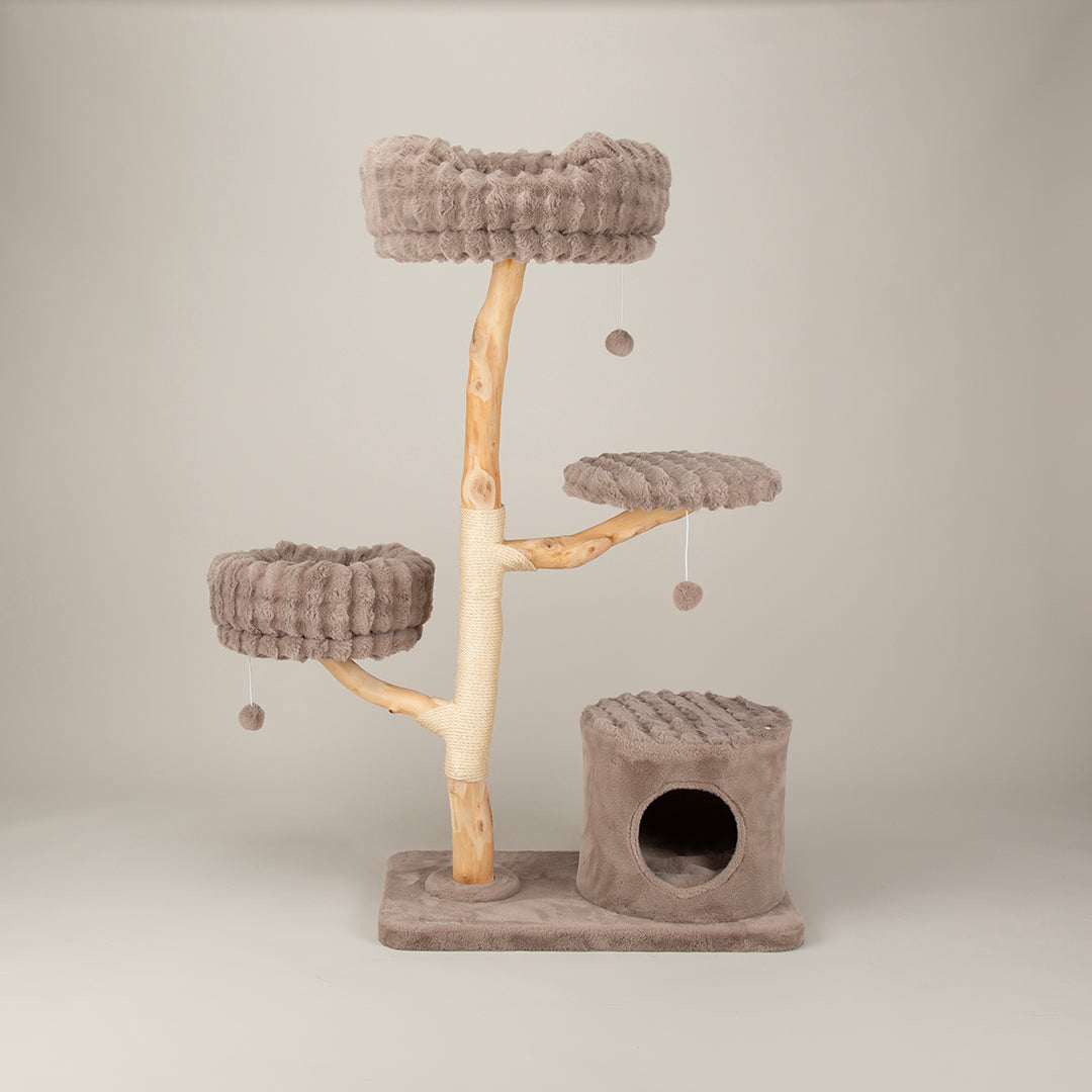 Cat tree tower with multiple platforms and three hanging balls on a plain background