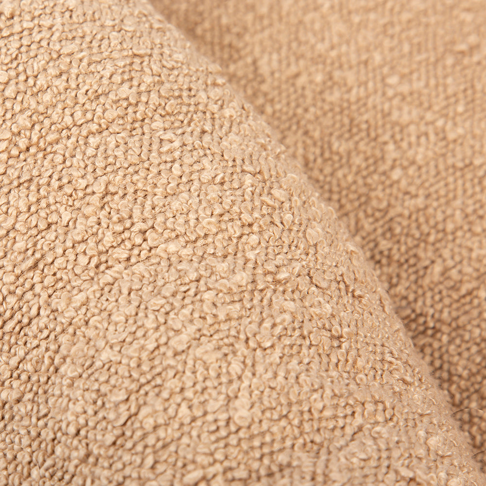 Close-up of beige textured fabric on a dog bed