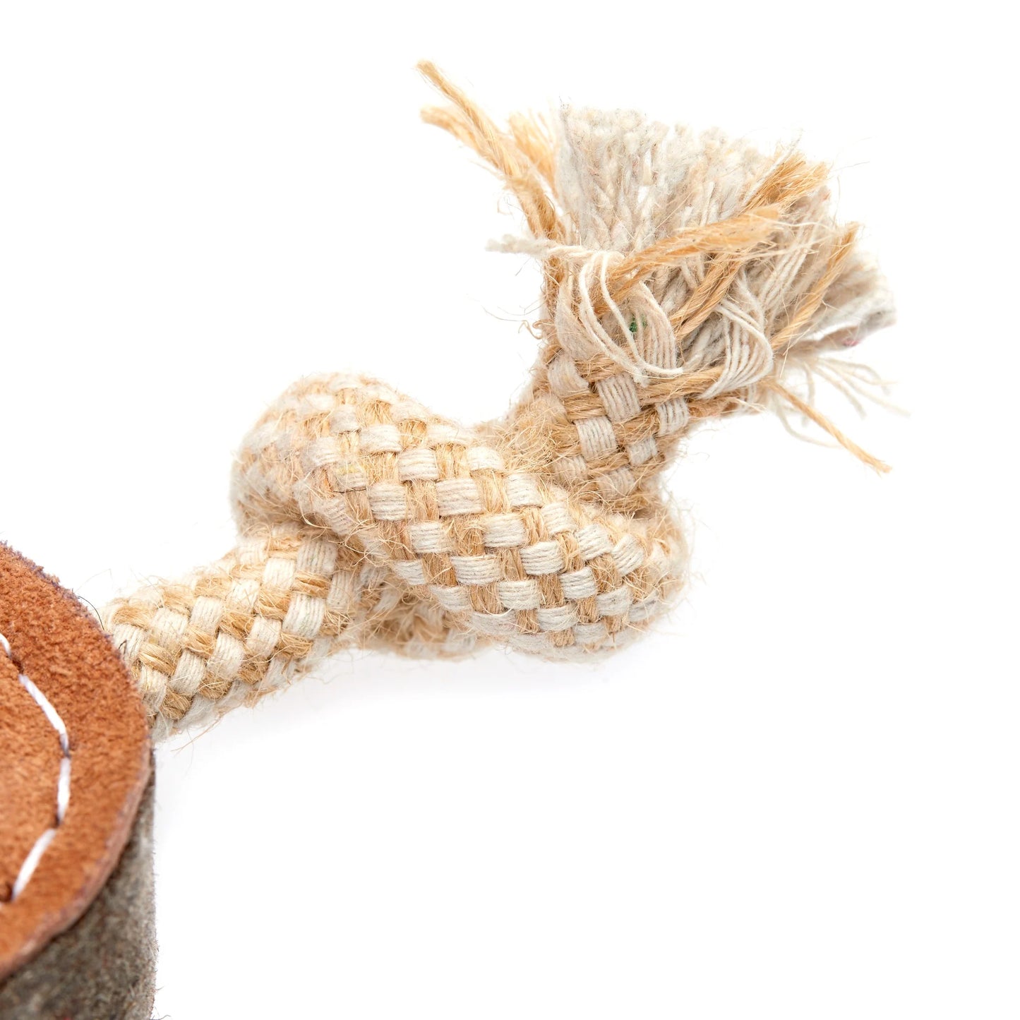 Close-up of a woven eco dog toy with a leather patch on a white background
