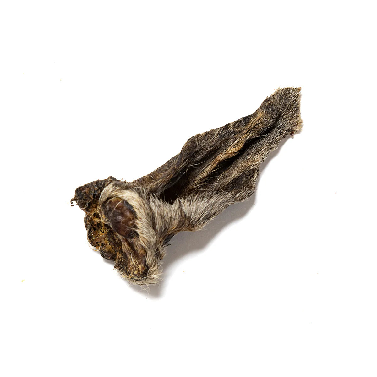 Lamb ear natural dog treats laid on an all white background.