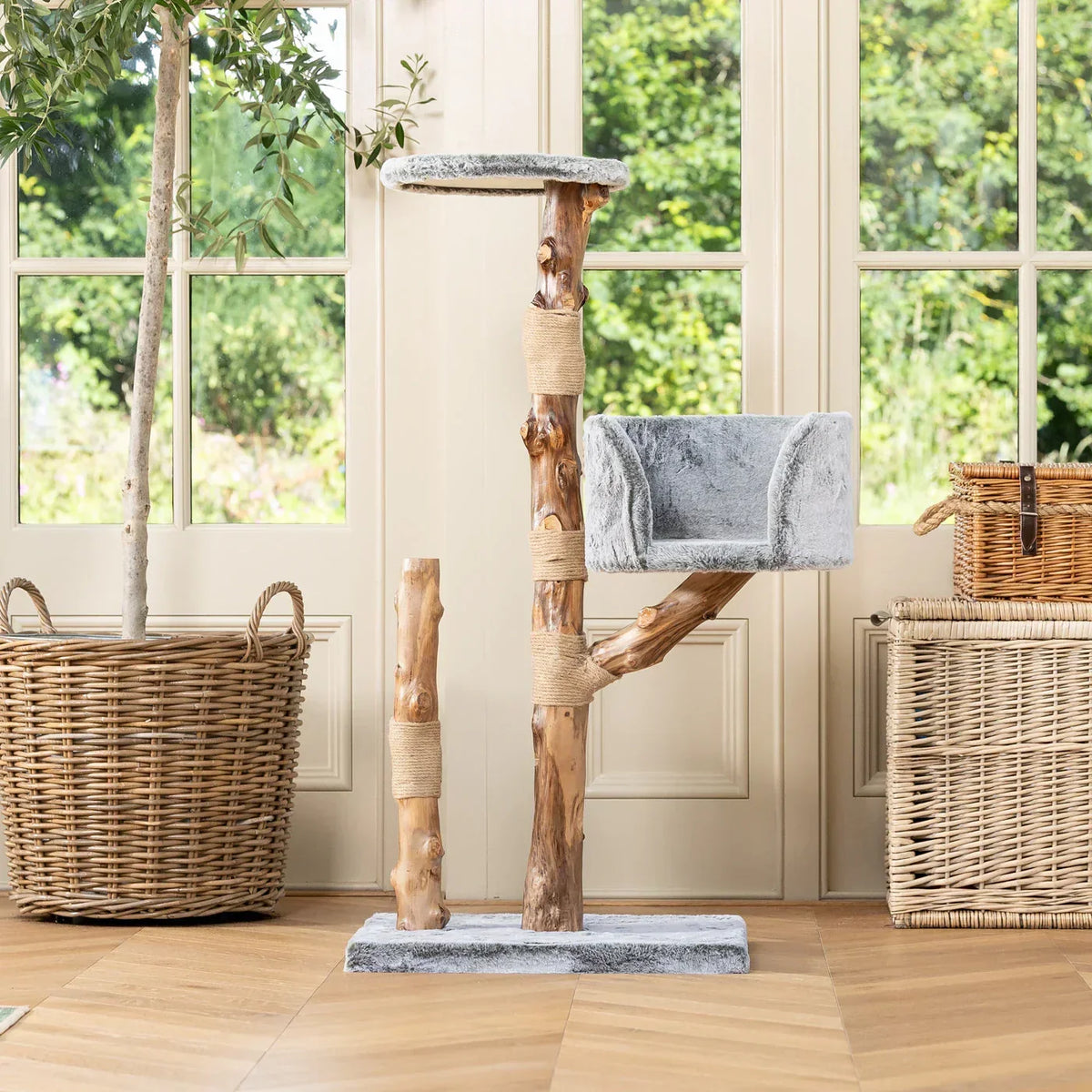 Lords & Labradors Back to Nature Trio cat tree with wooden posts and cushioned side bed in a bright room