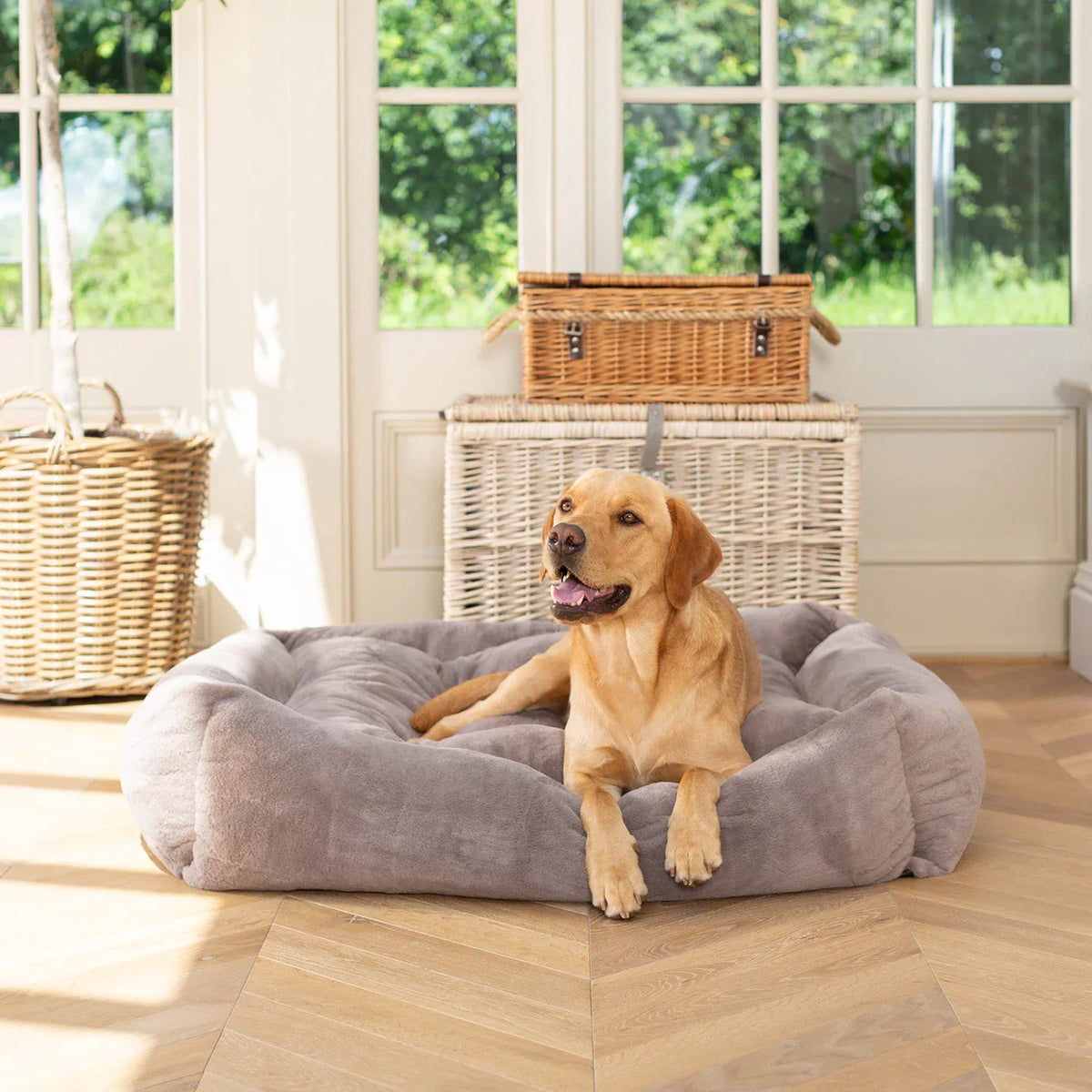 Lords & Labradors fawn faux fur box bed with raised cushioned edges in a light interior.