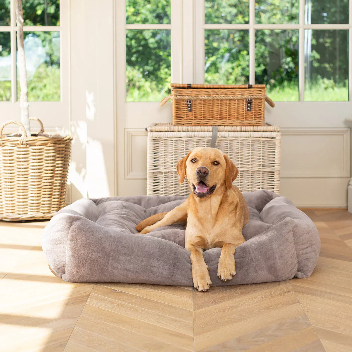 Lords & Labradors fawn calming anti anxiety faux fur box bed with dog resting indoors.