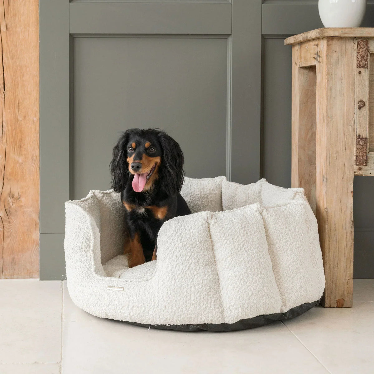 Lords & Labradors ivory boucle round high wall dog bed showing raised sides and soft inner cushion