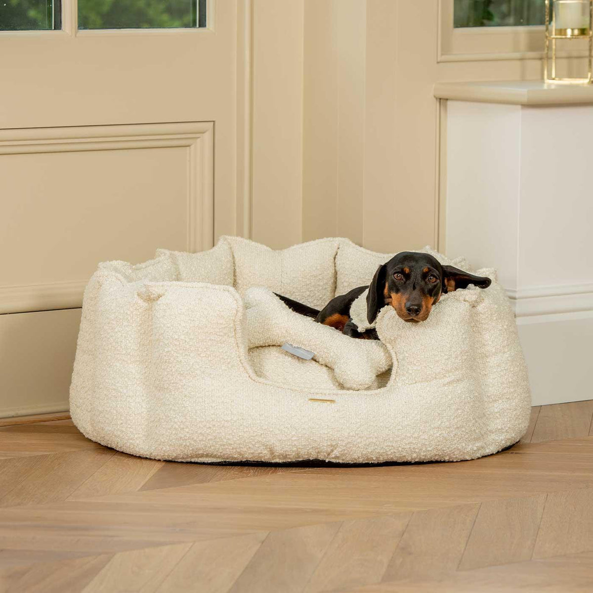 Lords & Labradors ivory boucle high wall dog bed with dog resting in a calm home setting