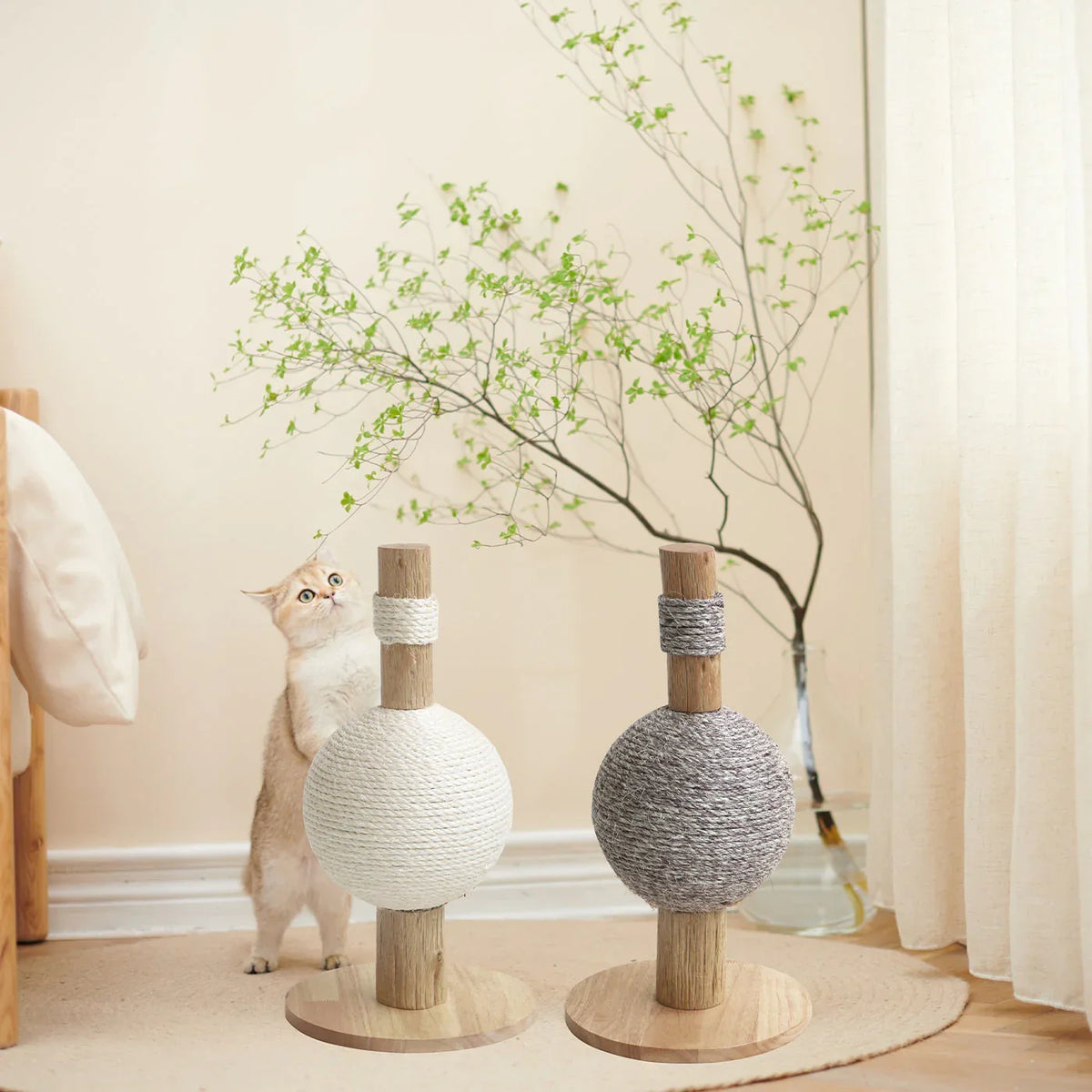 Lords & Labradors Helsinki cat scratching post with sisal ball in a living room with a cat beside it