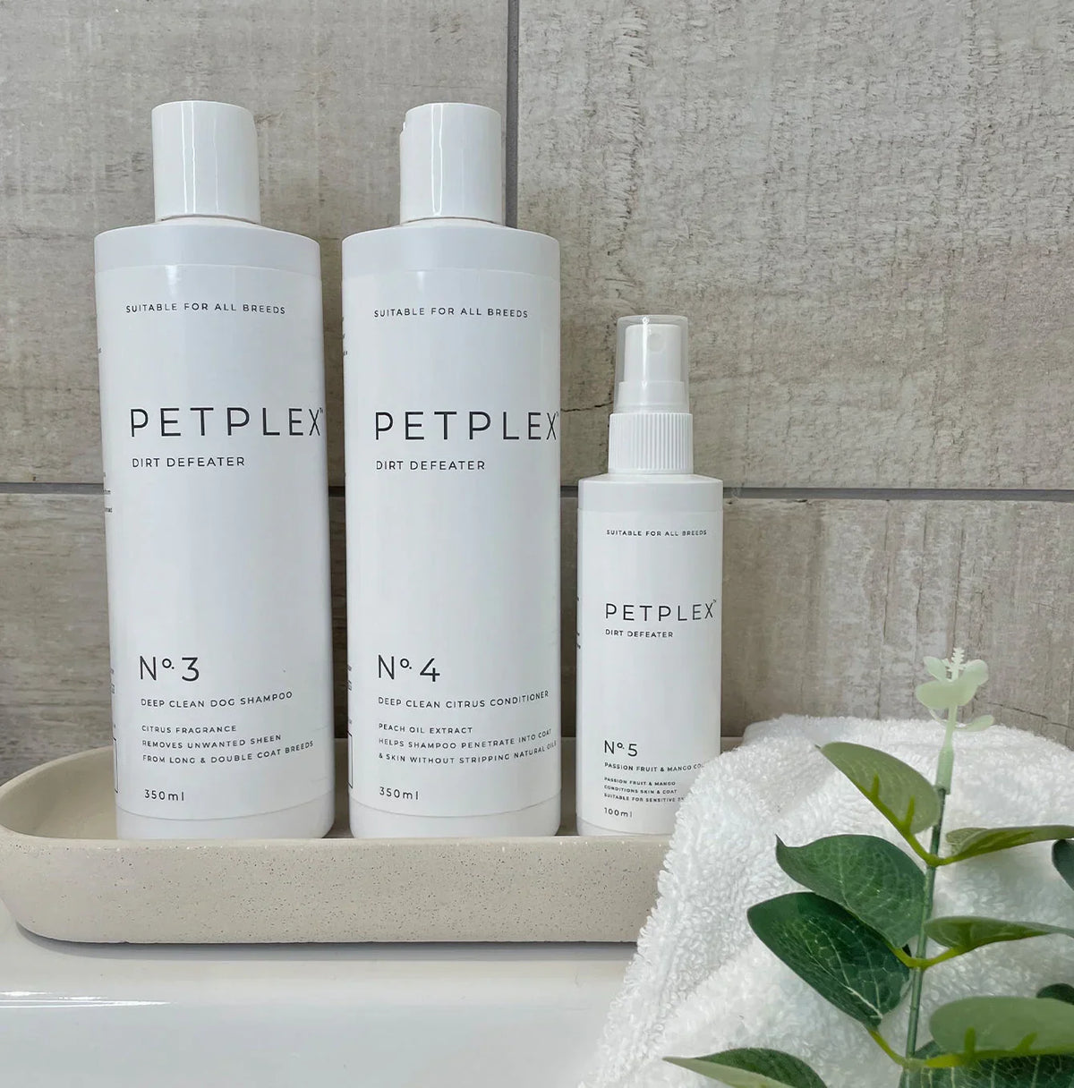 Deep clean shampoo, citrus conditioner and dog cologne displayed in a bathroom