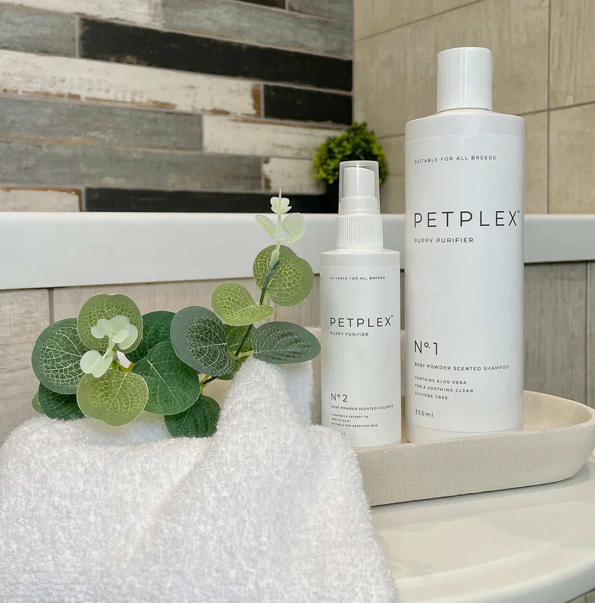 PetPlex puppy shampoo and baby fresh dog cologne displayed in a bathroom setting
