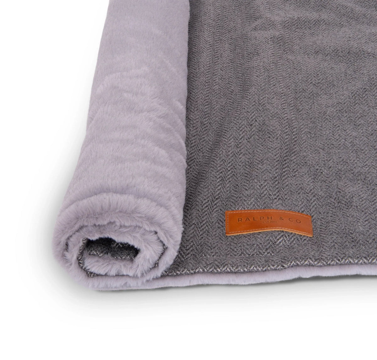 Close-up of the Ralph & Co logo on a dog blanket with soft sherpa reverse lining