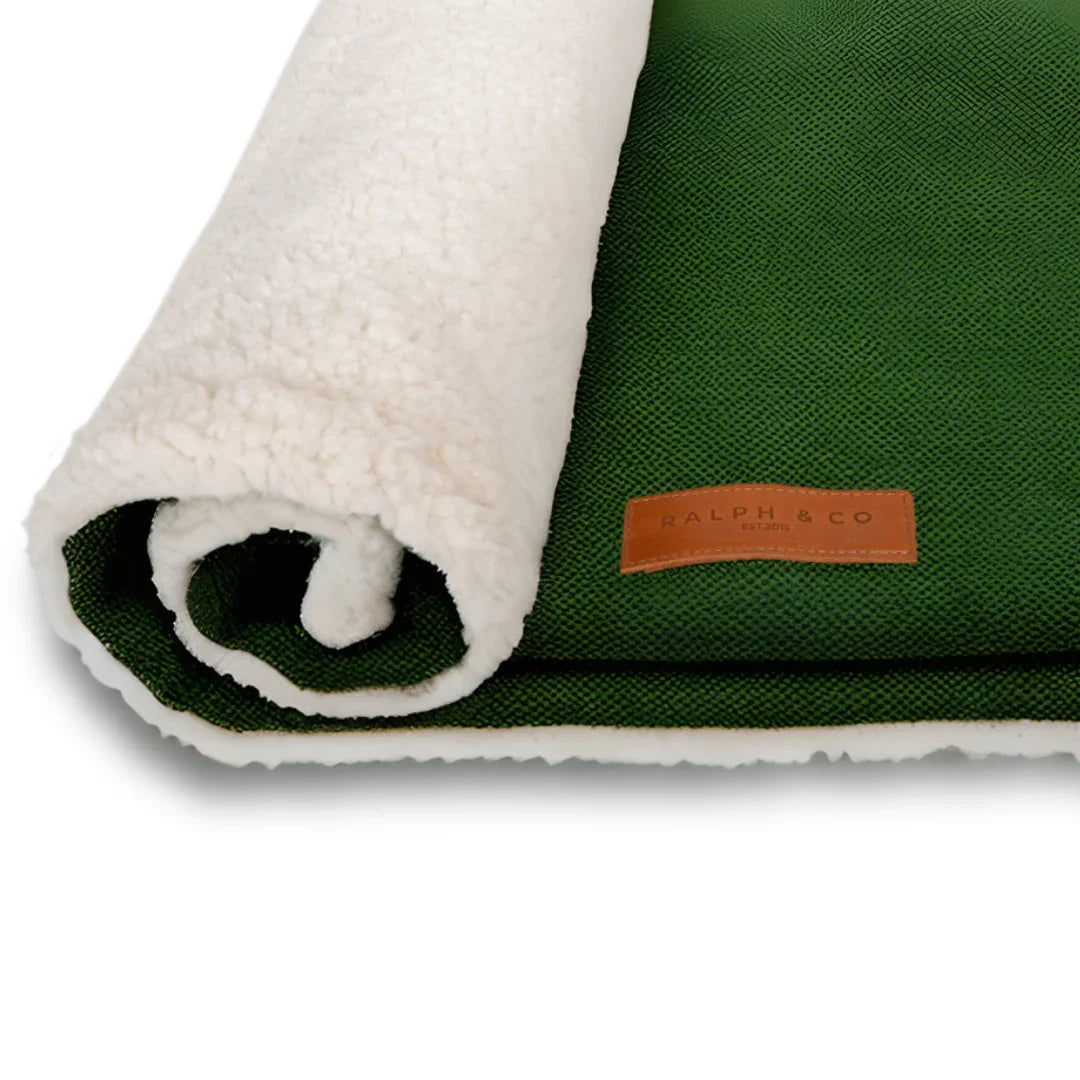Close-up of the Ralph & Co logo on a dog blanket with soft sherpa reverse lining