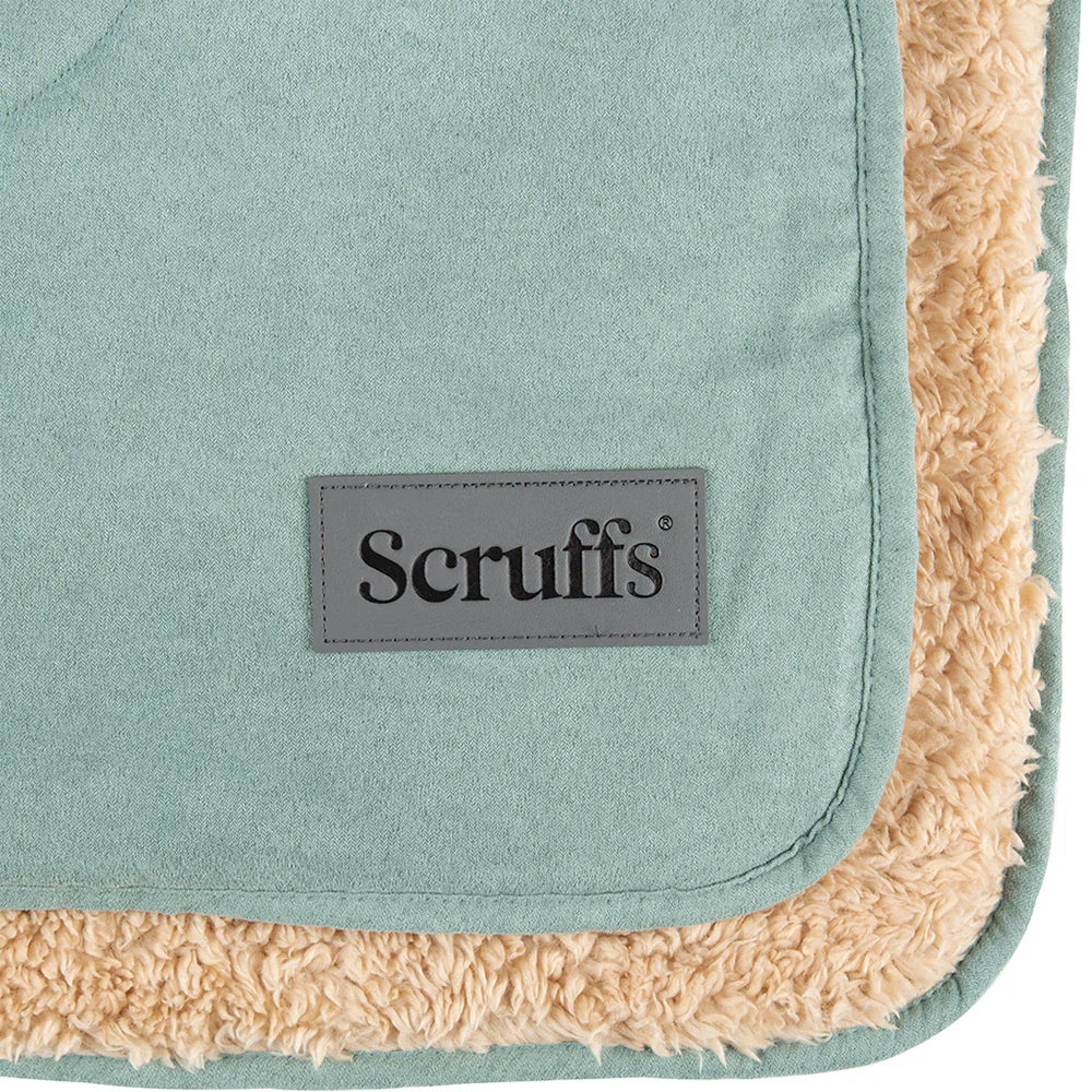 Close-up of the Scruffs logo on a sage green dog blanket with sherpa lining